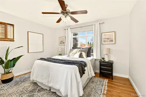 a bedroom with a bed and a potted plant