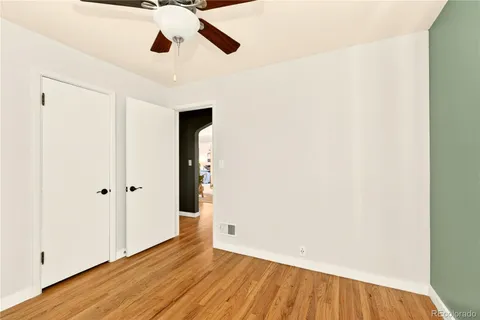 a view of an empty room with wooden floor