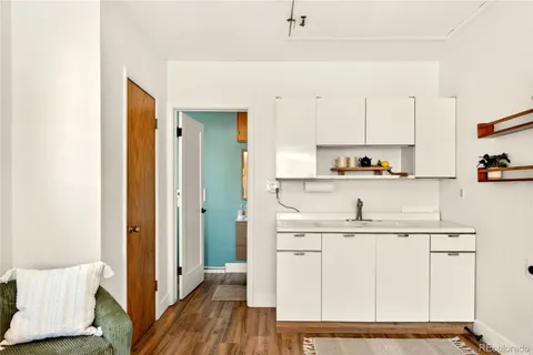 a kitchen with white cabinets appliances and sink