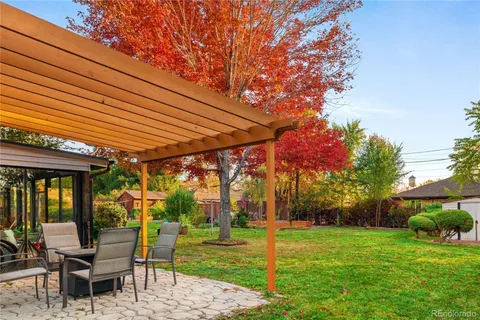 a patio with a yard table and chairs