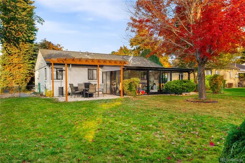 a front view of a house with yard patio and green space