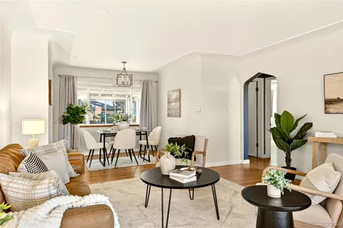 a living room with furniture potted plant and a window
