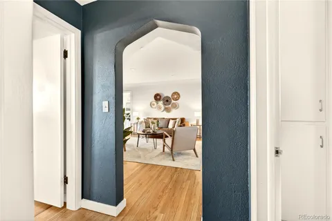 a dining room with wooden floor table and chairs
