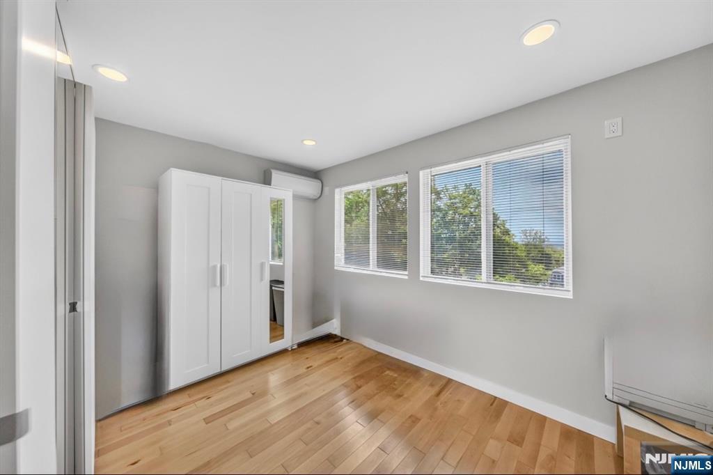 57 Hemlock Road Little Falls, NJ 07424 - Photo 22 of 50 a view of an empty room with wooden floor and a window