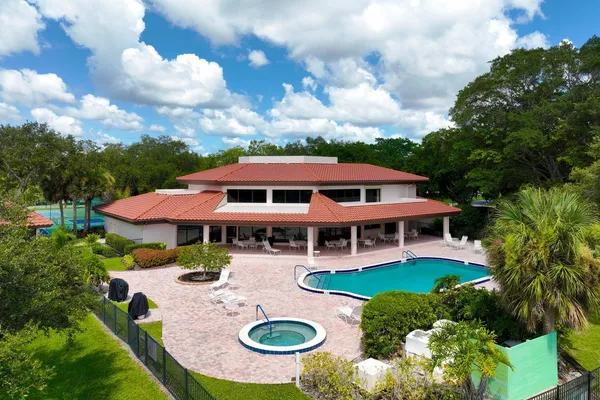 an aerial view of a house with swimming pool garden and patio