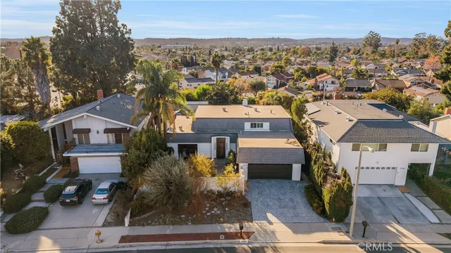 an aerial view of a house with garden space and street view