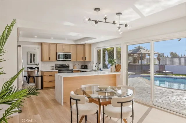 a large kitchen with a table and chairs in it