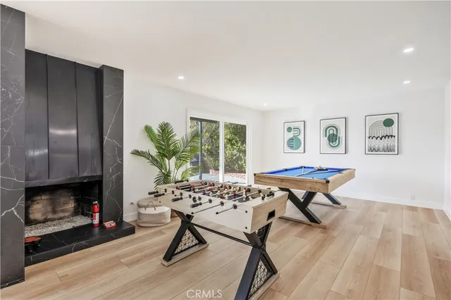 a living room with furniture a fireplace and a table