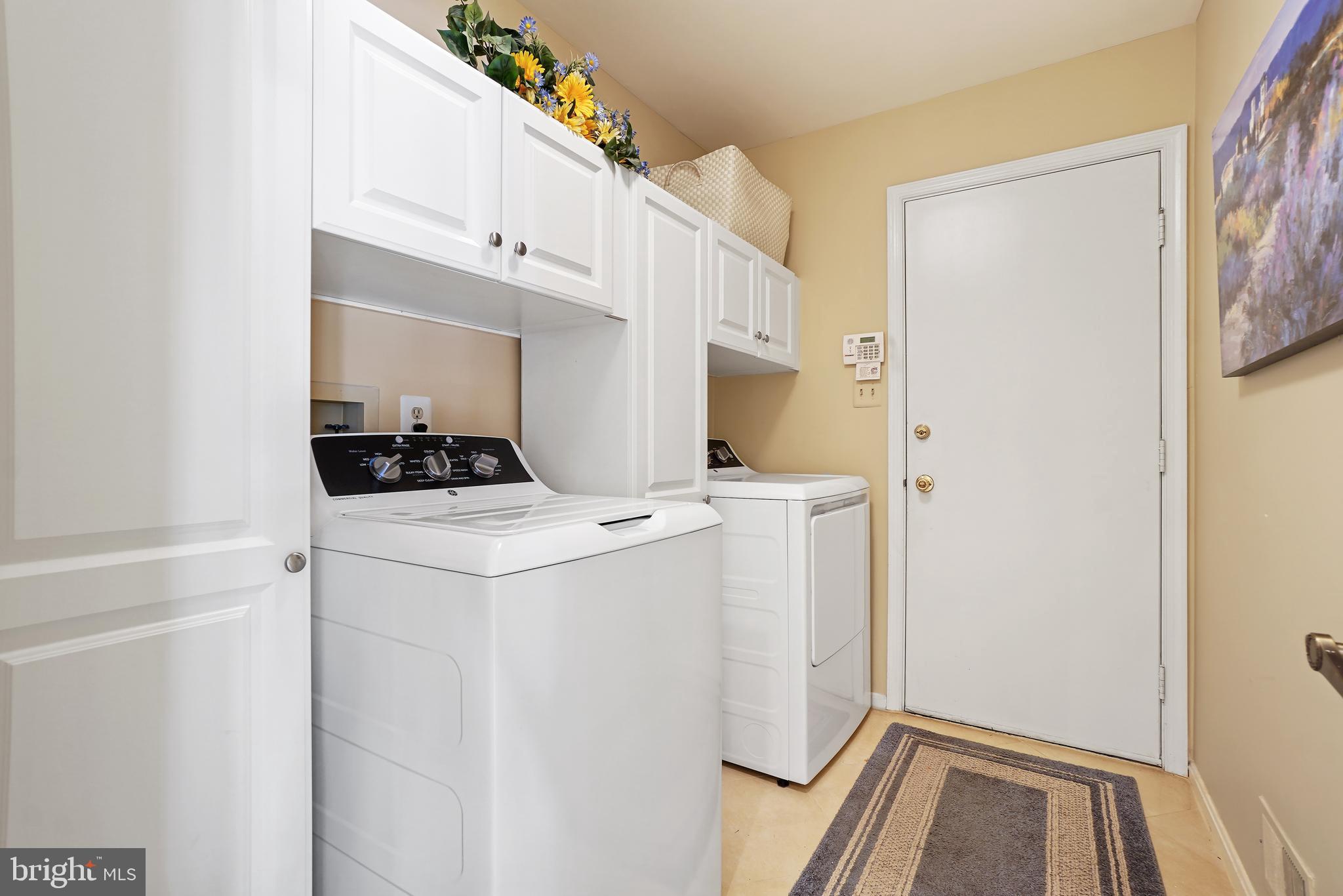 14716 Silverstone Drive Silver Spring, MD 20905 - Photo 43 of 48 1st floor laundry, newer washer/dryer, cabinets