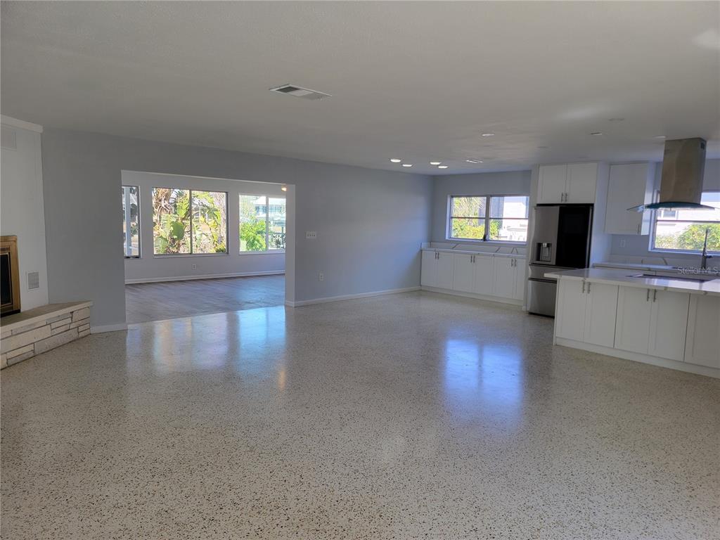 1732 Boca Raton Court Punta Gorda, FL 33950 - Photo 46 of 64 an empty room with windows a fireplace and wooden floor