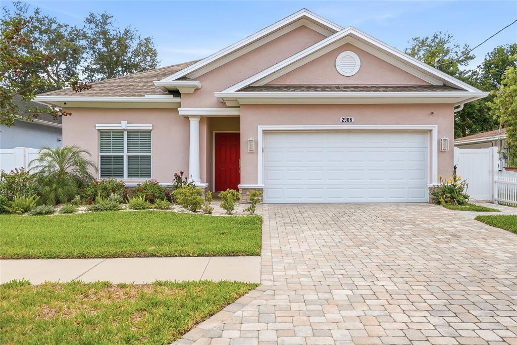 2906 West Douglas Street Tampa, FL 33607 - Photo 2 of 36 a view of a house with a small yard plants and a garage