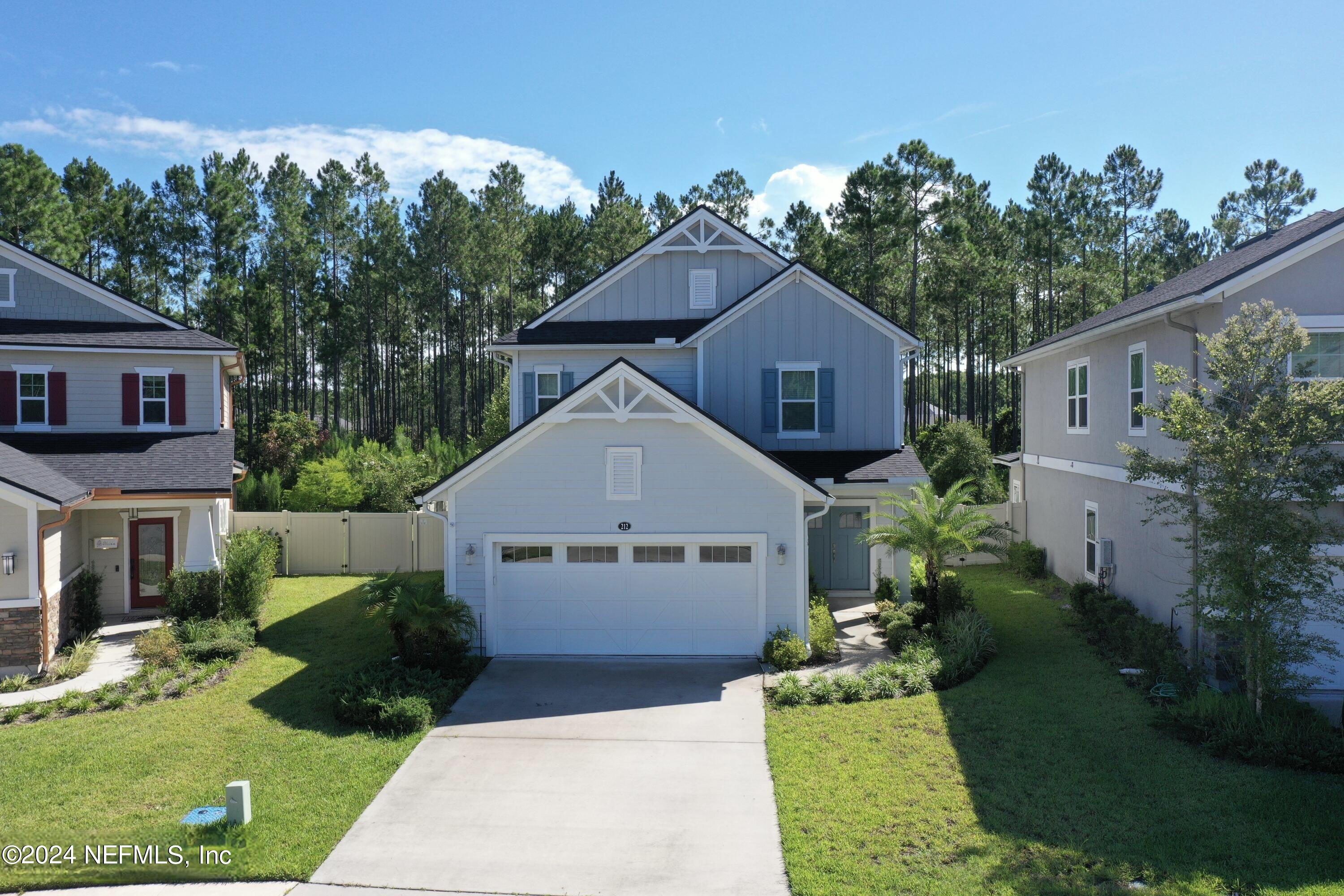 212 Concave Lane St. Augustine, FL 32095 - Photo 1 of 24 a front view of a house with a garden