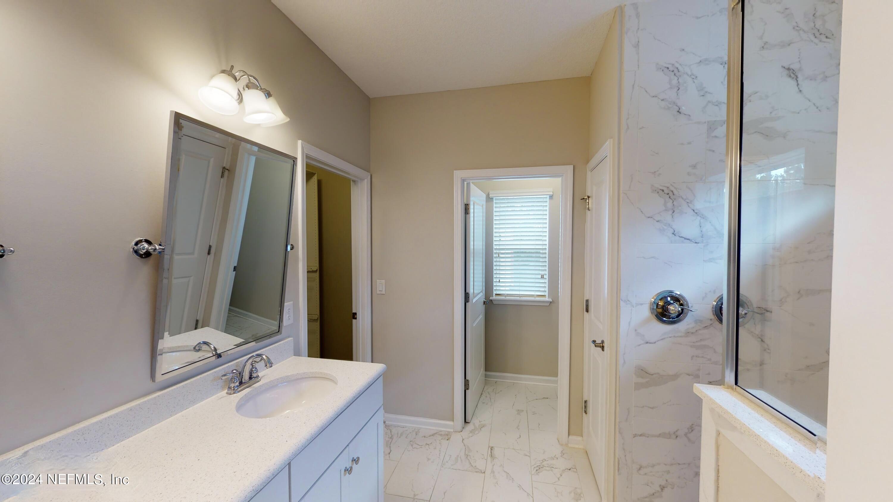 212 Concave Lane St. Augustine, FL 32095 - Photo 12 of 24 a bathroom with a bathtub and a sink