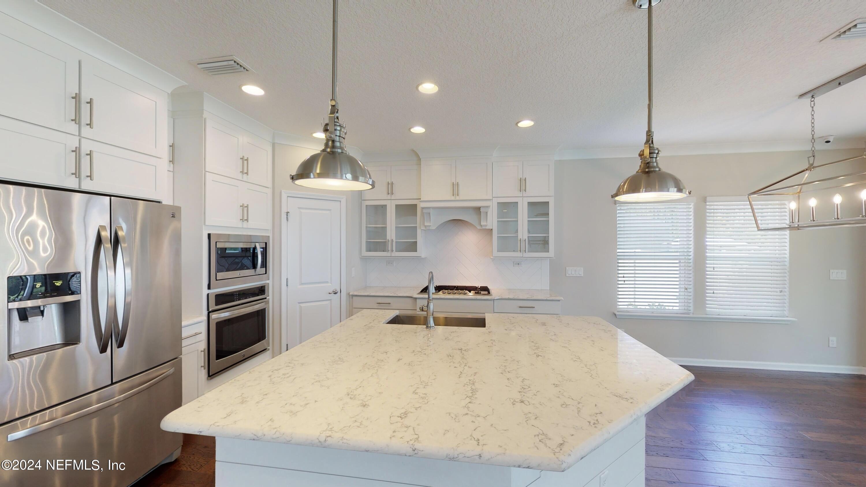 212 Concave Lane St. Augustine, FL 32095 - Photo 7 of 24 a large kitchen with kitchen island a stove a refrigerator a sink and a oven