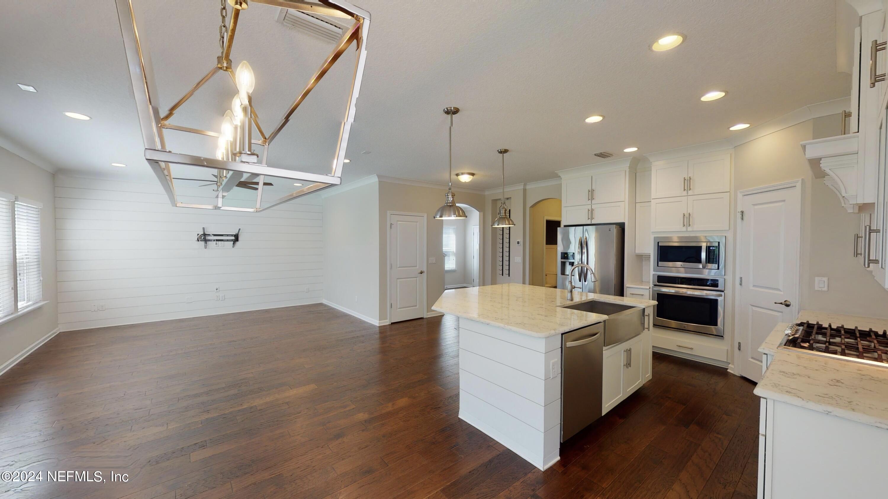 212 Concave Lane St. Augustine, FL 32095 - Photo 8 of 24 a open kitchen with kitchen island a stove and a refrigerator