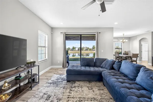 a living room with furniture and kitchen view