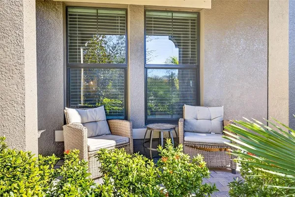 a living room filled with furniture and a potted plant