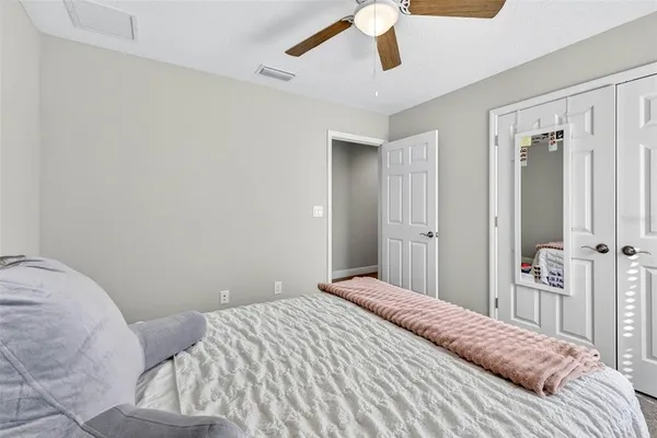 a bedroom with a bed and a chair in it