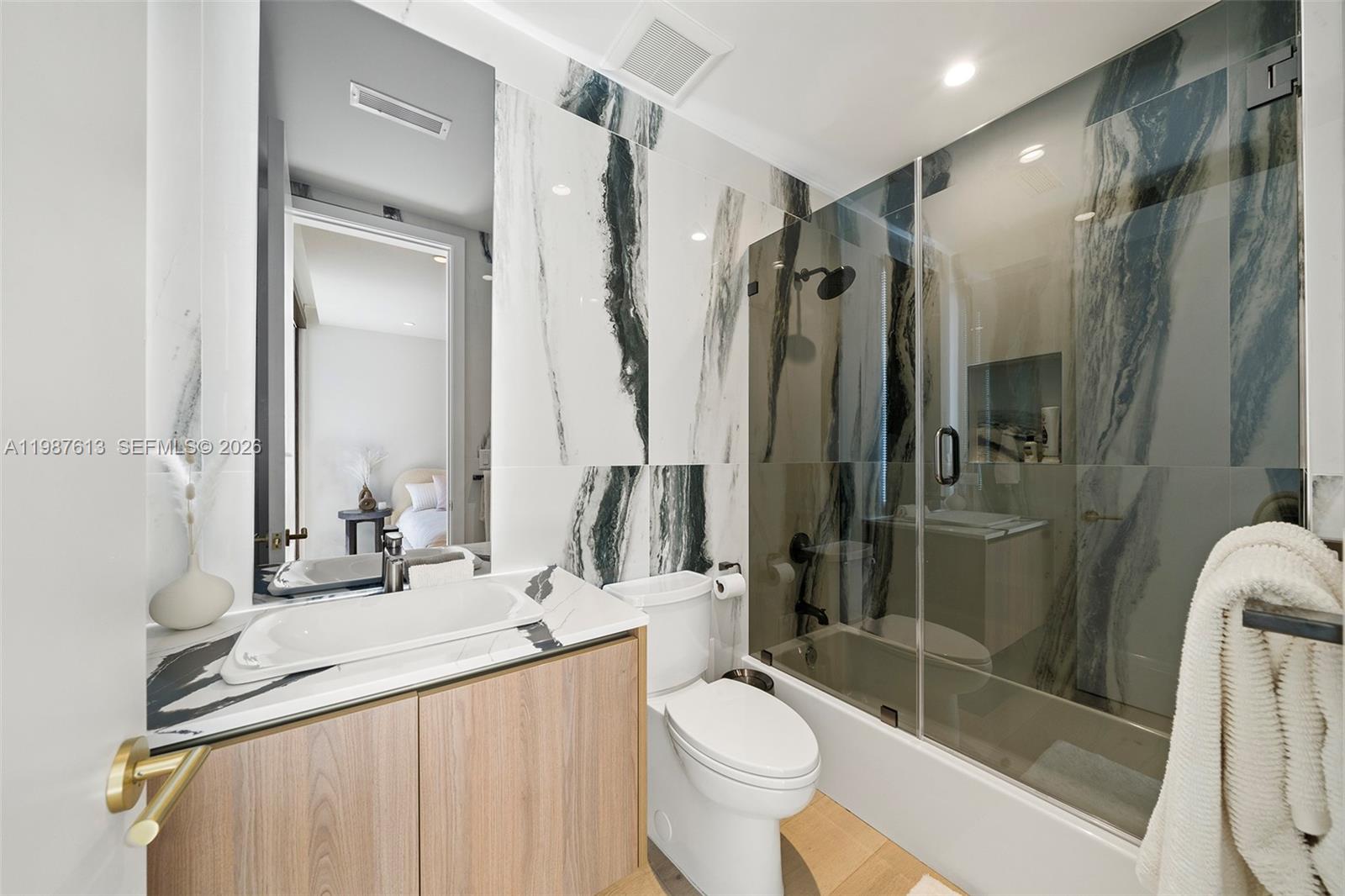 4041 South Le Jeune Road Miami, FL 33133 - Photo 11 of 30 a bathroom with a double vanity sink toilet and shower