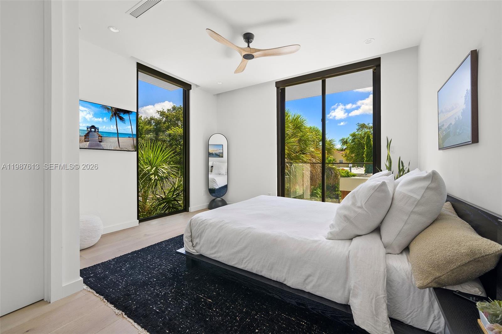 4041 South Le Jeune Road Miami, FL 33133 - Photo 13 of 30 a large bed sitting in a bedroom next to a window