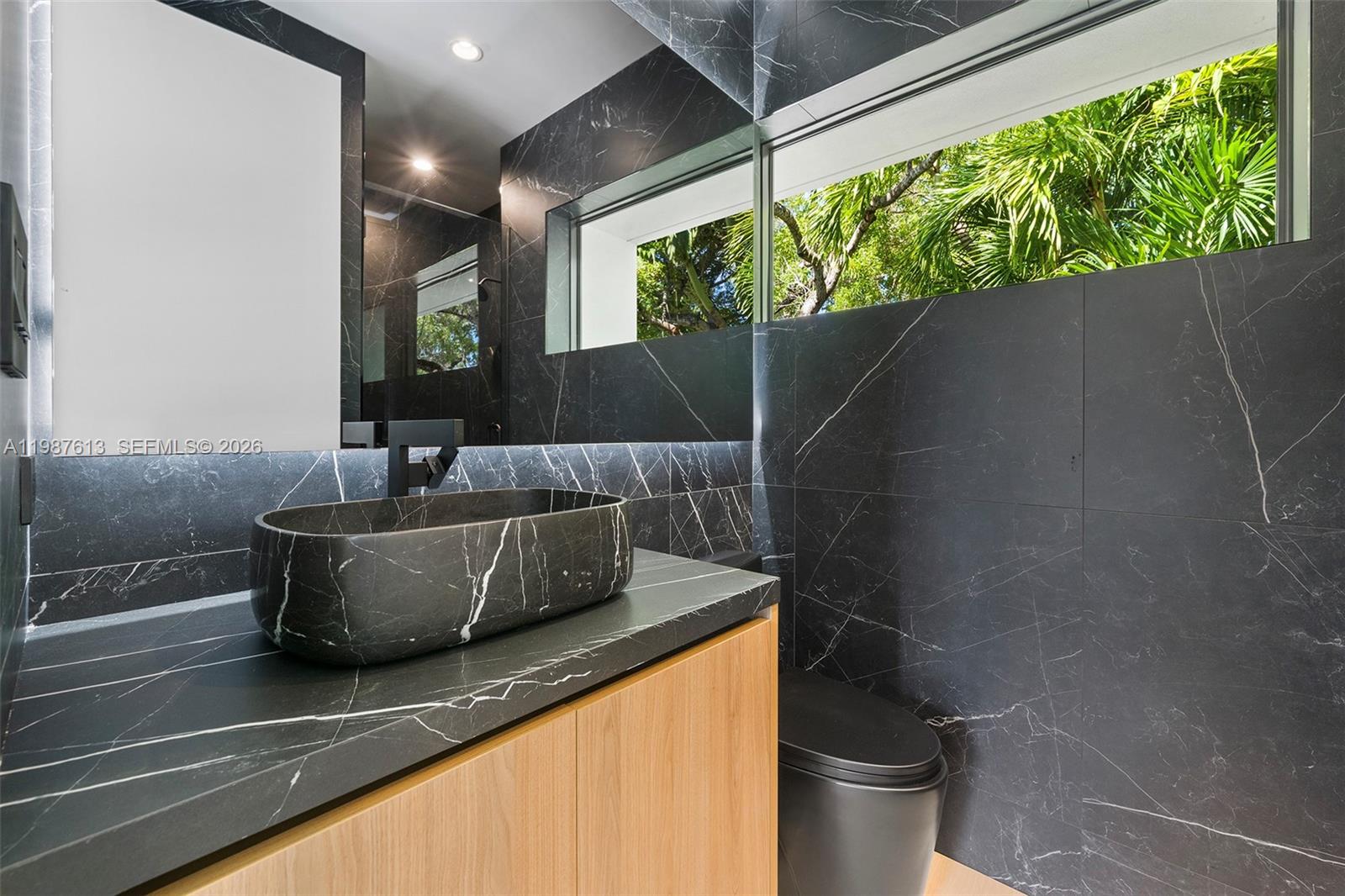 4041 South Le Jeune Road Miami, FL 33133 - Photo 14 of 30 a living room with a couch and a potted plant