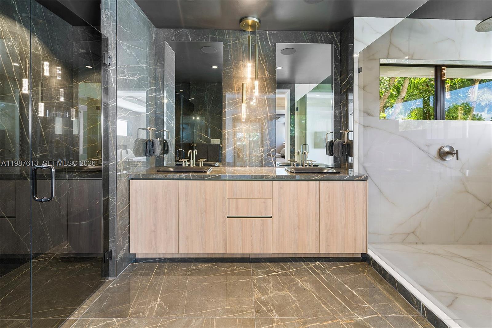 4041 South Le Jeune Road Miami, FL 33133 - Photo 17 of 30 a bathroom with a double vanity sink a mirror and a shower