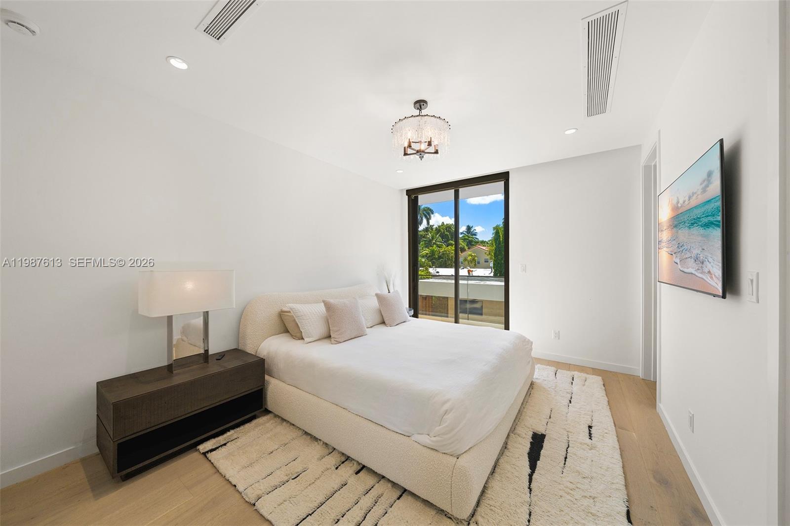 4041 South Le Jeune Road Miami, FL 33133 - Photo 20 of 26 a bedroom with a bed and a table