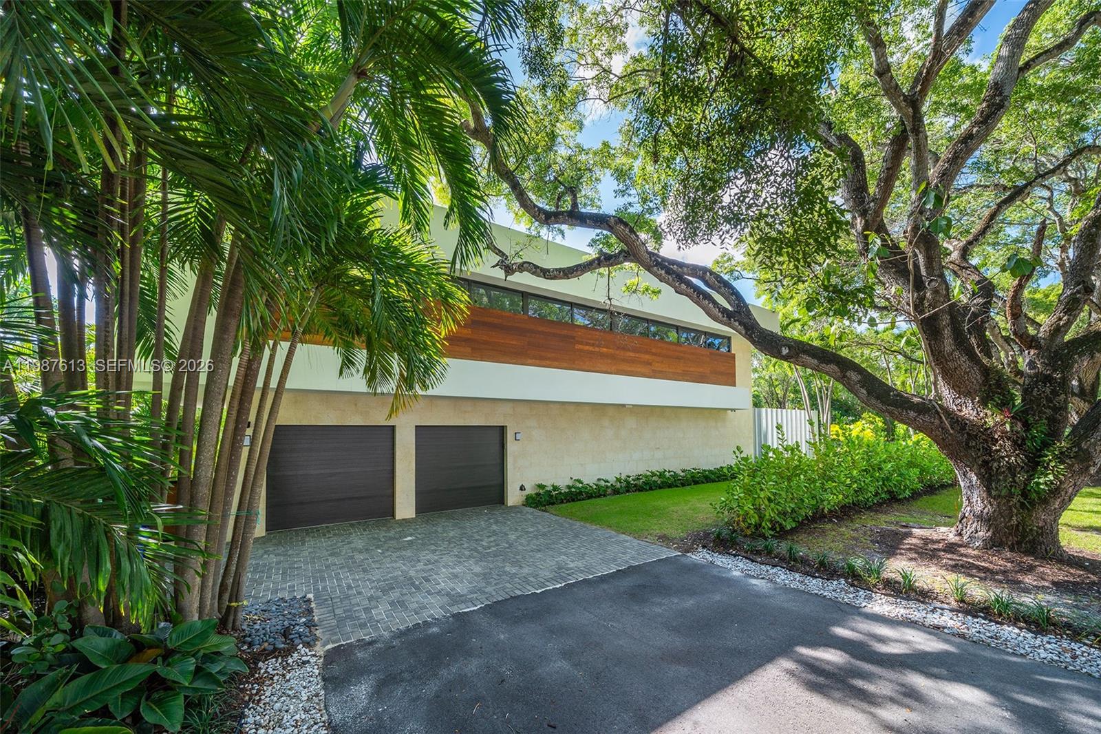 4041 South Le Jeune Road Miami, FL 33133 - Photo 3 of 30 a front view of a house with a yard and a large tree