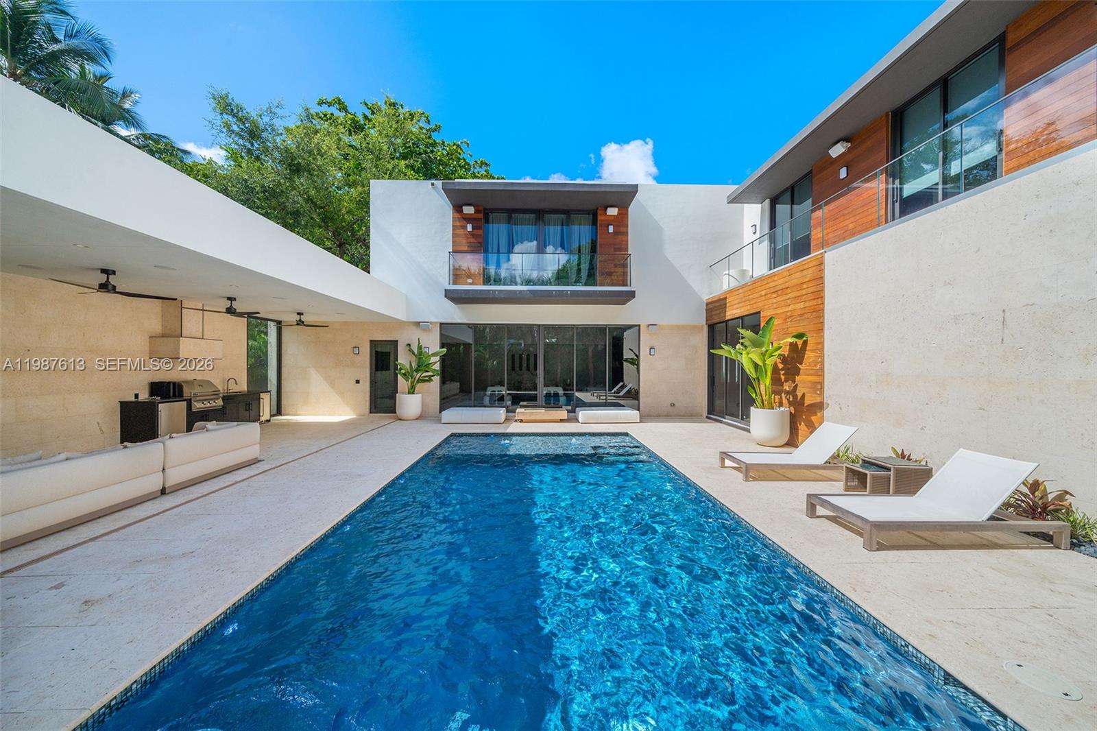 4041 South Le Jeune Road Miami, FL 33133 - Photo 4 of 30 a view of a house with swimming pool and sitting area