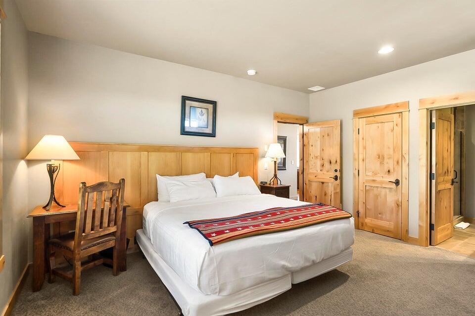 16845 South W Brasada Ranch Road, Unit 23 Powell Butte, OR 97753 - Photo 10 of 47 a spacious bedroom with a bed and a lamp