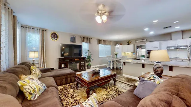 a living room with furniture a rug and a chandelier