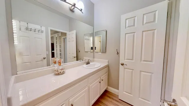 a bathroom with a double vanity sink a mirror and a shower