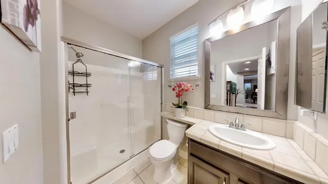 a bathroom with a sink toilet and shower