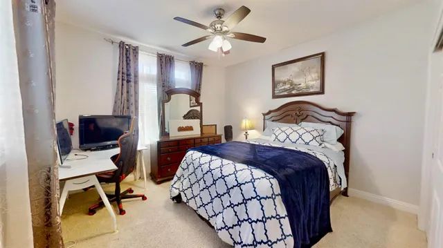 a bedroom with a large bed and a dresser