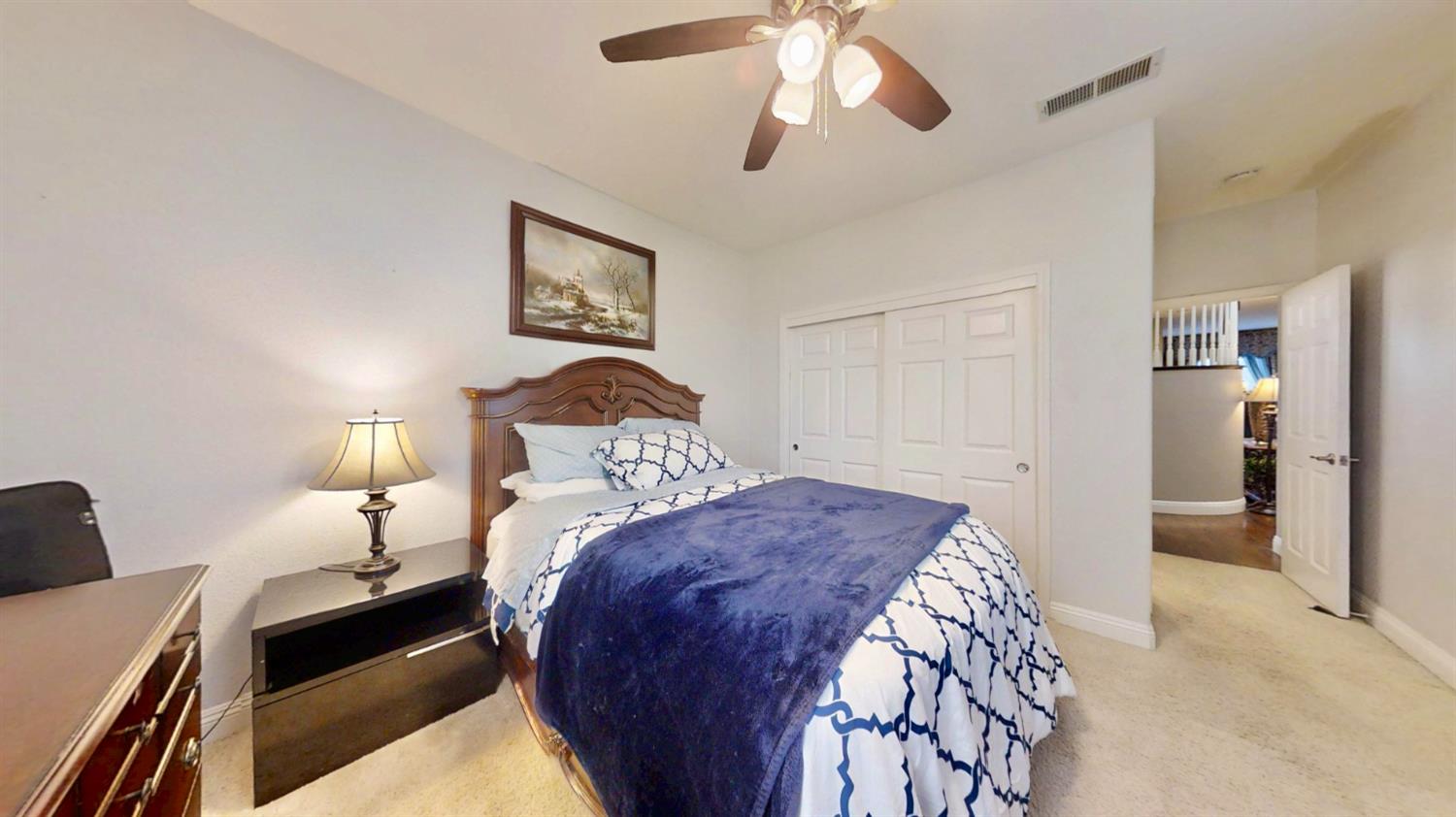 9573 Spring River Way Elk Grove, CA 95624 - Photo 39 of 53 a bedroom with a bed and a chandelier