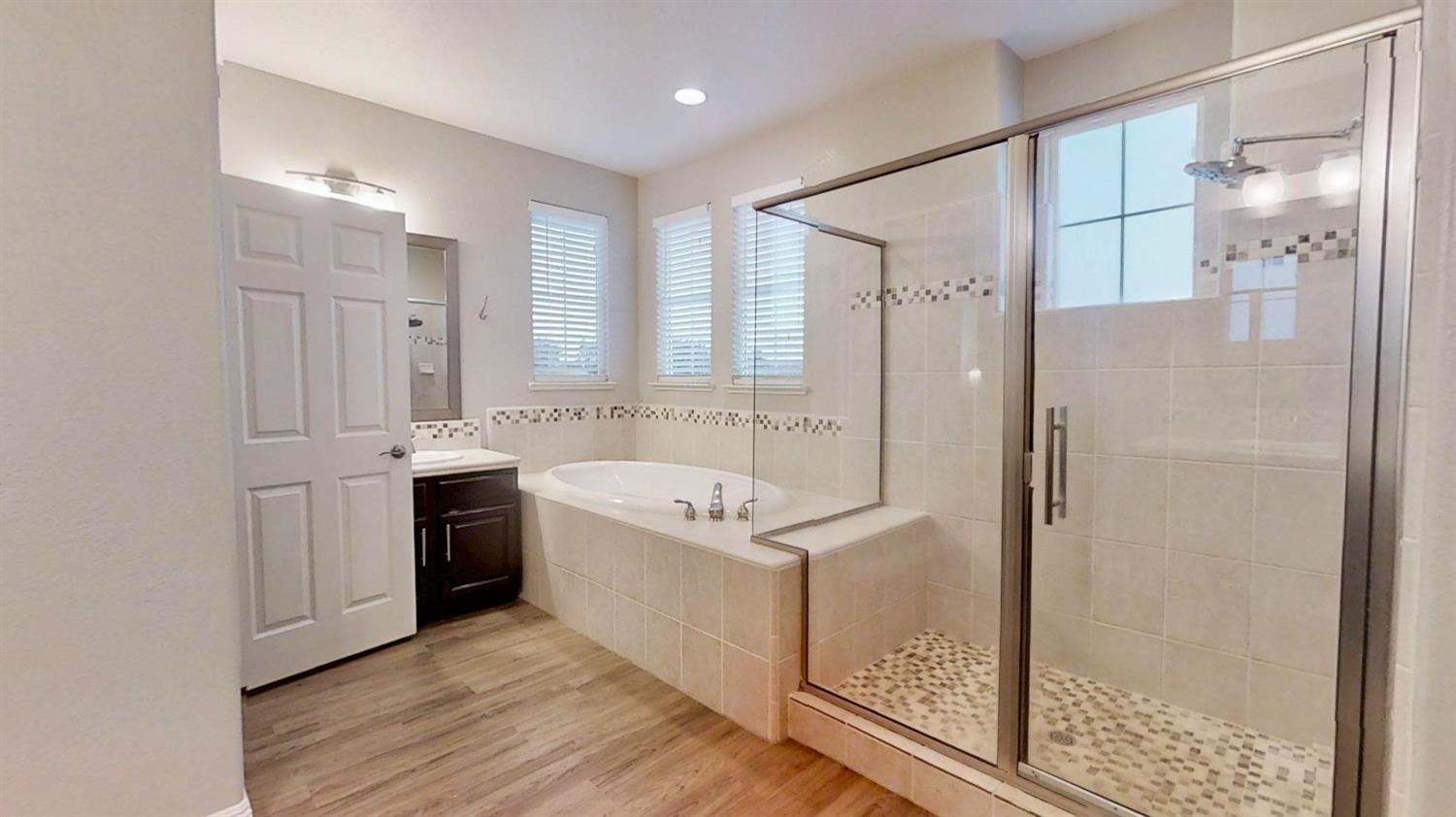 9573 Spring River Way Elk Grove, CA 95624 - Photo 46 of 53 a bathroom with a tub sink shower and mirror