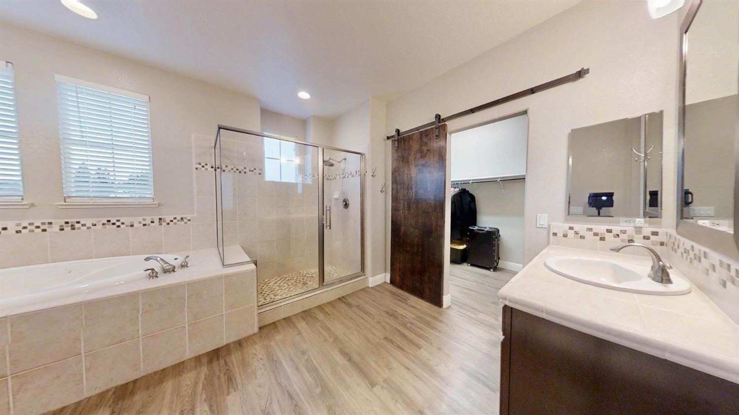 9573 Spring River Way Elk Grove, CA 95624 - Photo 47 of 53 a bathroom with a tub sink and mirror