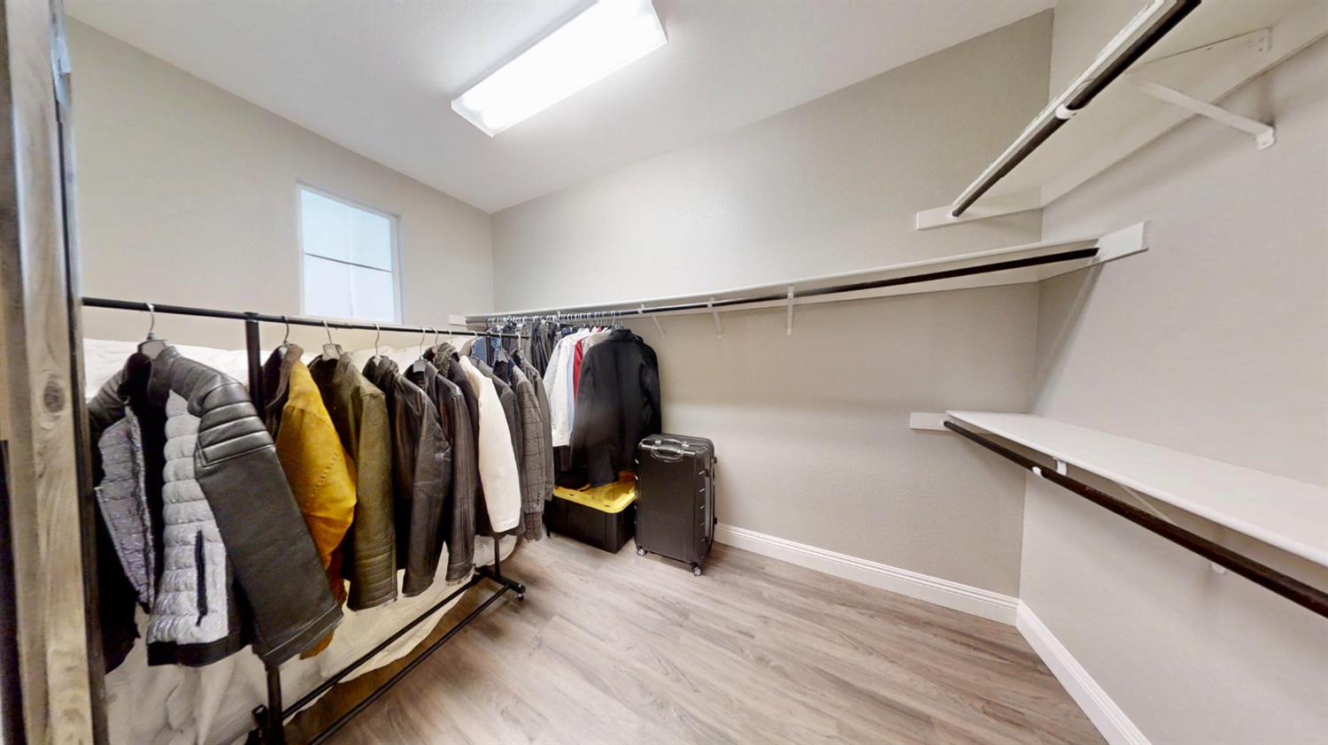 9573 Spring River Way Elk Grove, CA 95624 - Photo 48 of 53 a view of walk in closet with clothes and shoes