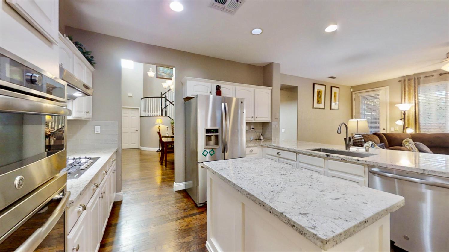 9573 Spring River Way Elk Grove, CA 95624 - Photo 9 of 53 a kitchen with a center island and stainless steel appliances