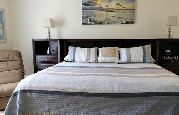 a bedroom with a bed and lamps