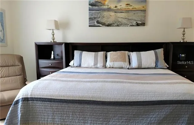 a bedroom with a bed and lamps