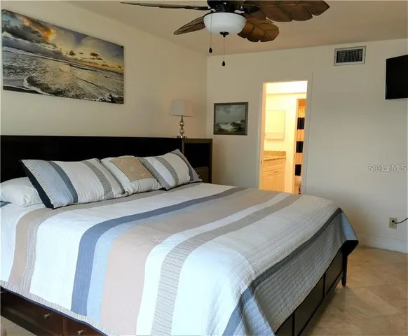 a bedroom with bed and wooden floor