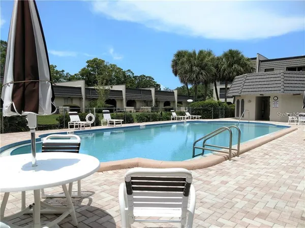 a swimming pool with outdoor seating and yard