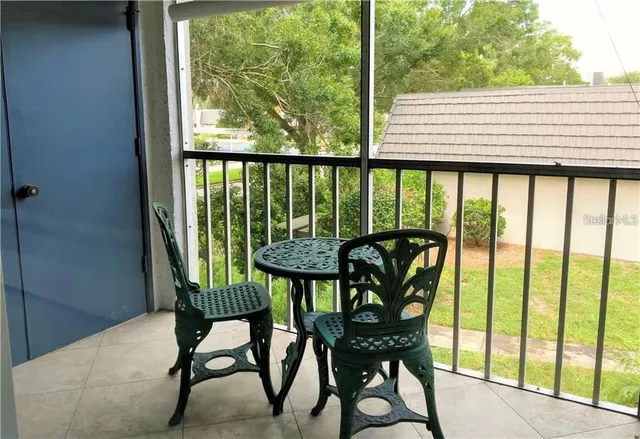 a view of a balcony with chairs and a table