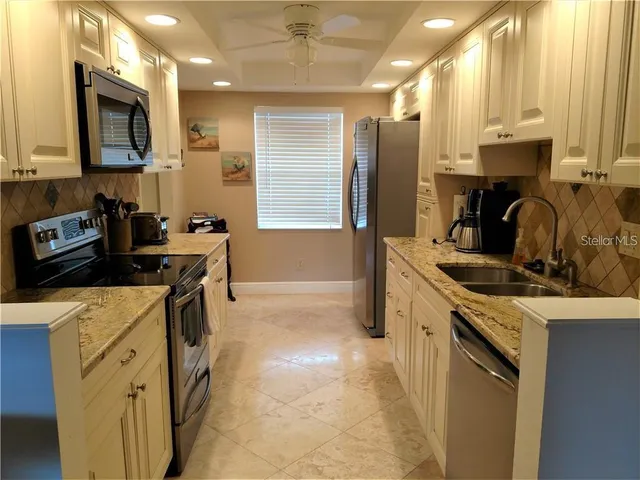 a kitchen with a sink stove and refrigerator