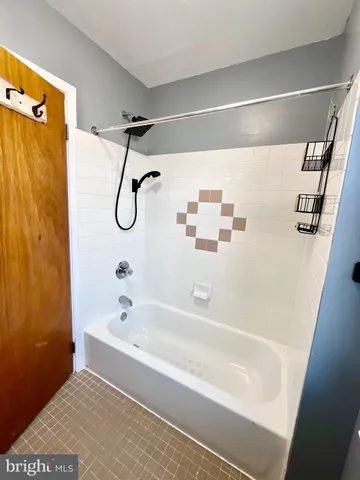 a bathroom with a shower and a bath tub