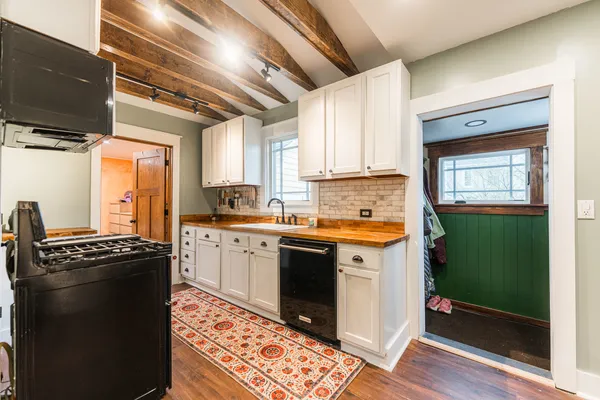 a kitchen with a stove sink and cabinets