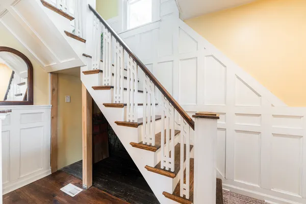 a view of entryway with wooden floor and stairs