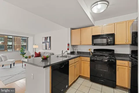 a kitchen with a sink stove top oven and microwave