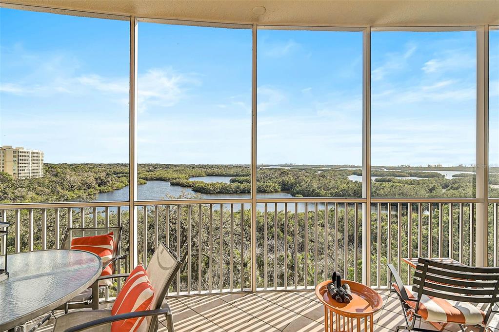 a view of a balcony with chair and table